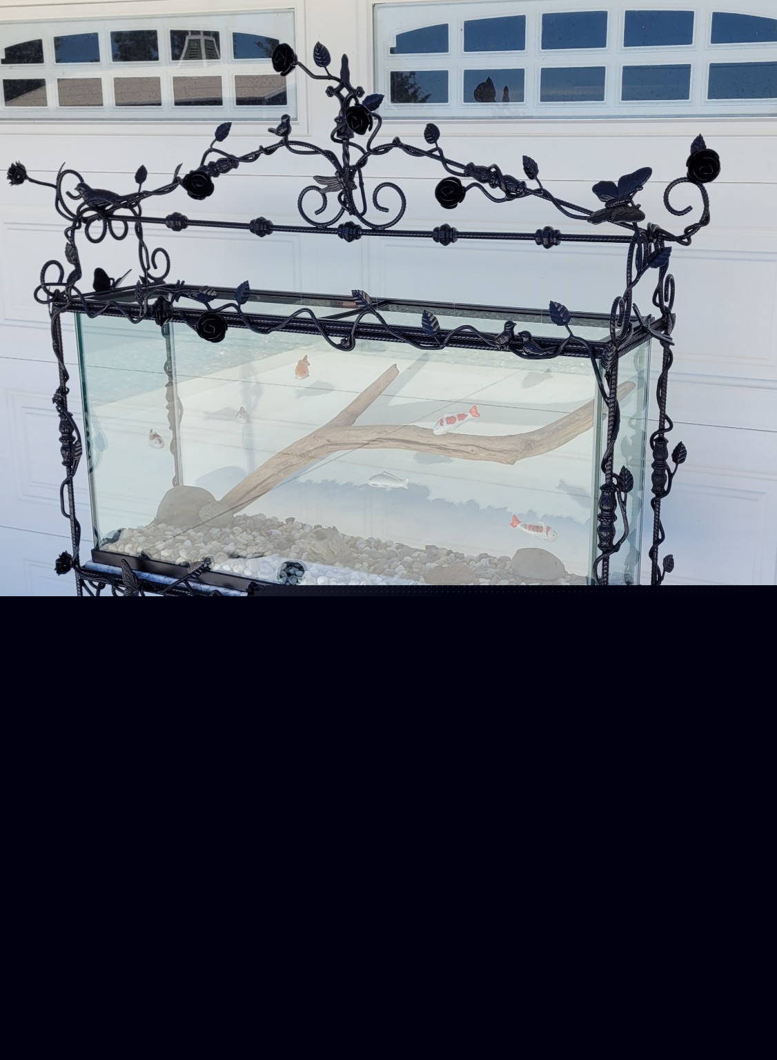 The Secret Garden aquarium with black steel roses, climbing vines and an ornate stand